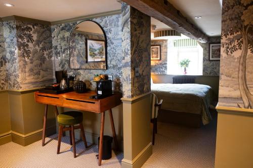 a bedroom with a bed and a desk and a table at The Unicorn, Ambleside in Ambleside