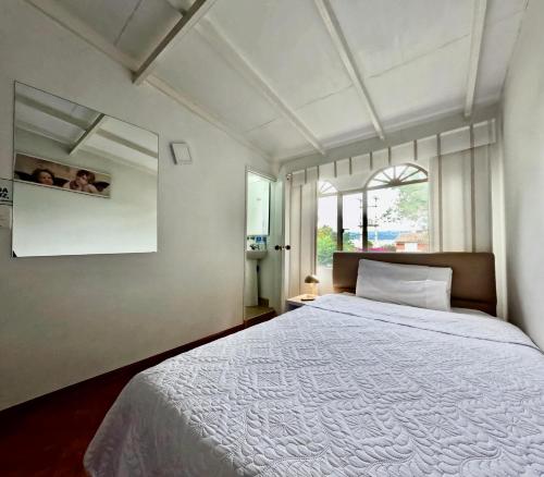 a bedroom with a large bed and a window at Hotel Casa Iris in Chía