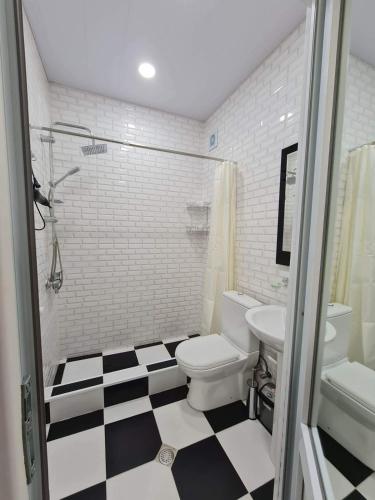 a bathroom with a black and white checkered floor at Hotel Tabidze in Batumi