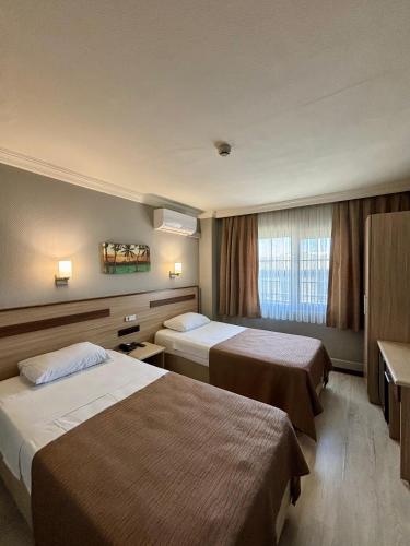 a hotel room with two beds and a window at Gold Hotel in Istanbul