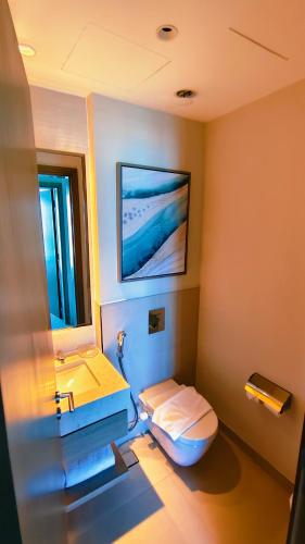 a bathroom with a toilet and a sink at Apartment at Vida Marina Marassi, North Coast in El Alamein