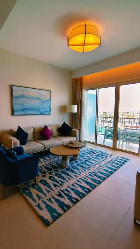 a living room with a couch and a table at Apartment at Vida Marina Marassi, North Coast in El Alamein
