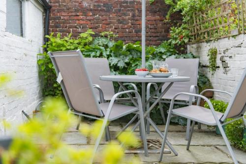 a table and chairs on a patio at Captains Cottage in Deal