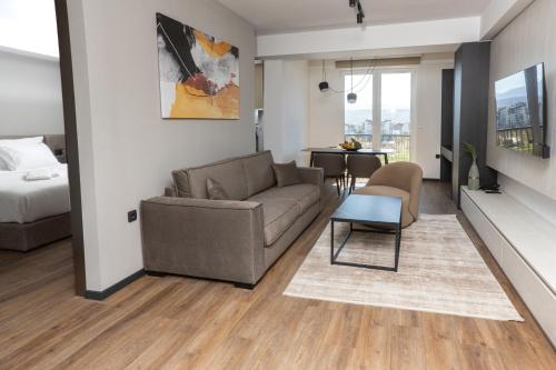 a living room with a couch and a table at Hotel Cube 55 - Business Suites in Skopje