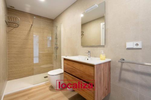 a bathroom with a sink and a toilet and a shower at Amplio y moderno apartamento in Almería