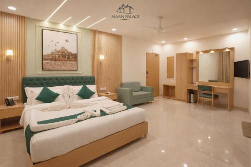 a hotel room with a large bed and a salon at The Grand Maan Palace and Resort- Near Vaishali Nagar I New Building in Jaipur
