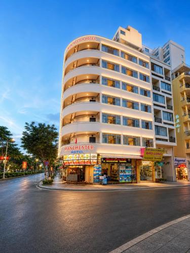 a large building on the side of a street at Anh Minh - Manchester Hotel Tran Phu Beach Nha Trang in Nha Trang