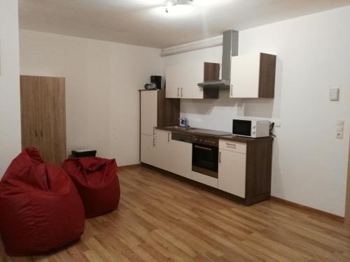 a living room with a kitchen with a couch and a refrigerator at Ferienwohnung Mair in Umhausen