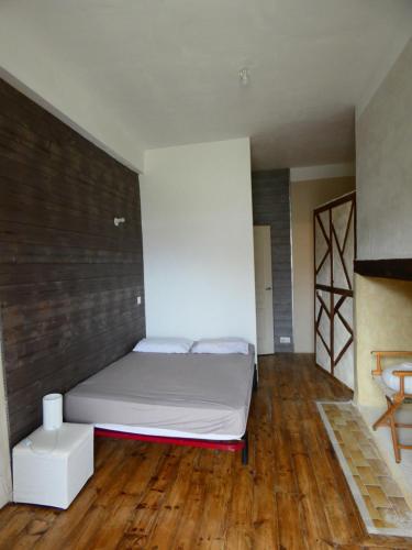 a bedroom with a bed and a wooden floor at Air de Monade in Oloron-Sainte-Marie