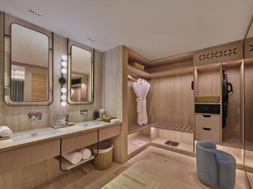 a bathroom with two sinks and a mirror at The Forum Hotel and Convention in Ahmedabad