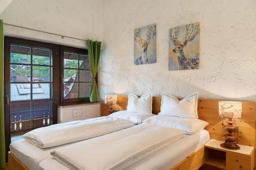 a bedroom with two beds with white pillows at Appartement Azalea Oetz in Oetz