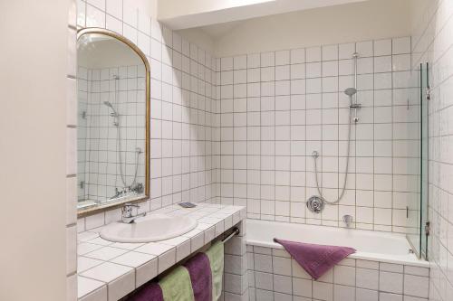 a white bathroom with a sink and a shower at Appartement Azalea Oetz in Oetz