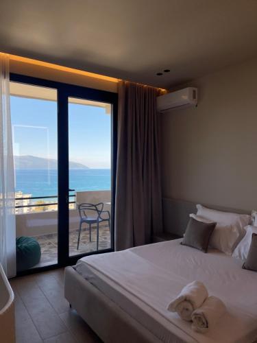 a bedroom with a bed and a view of the ocean at Seamare Studio & Apartaments in Vlorë