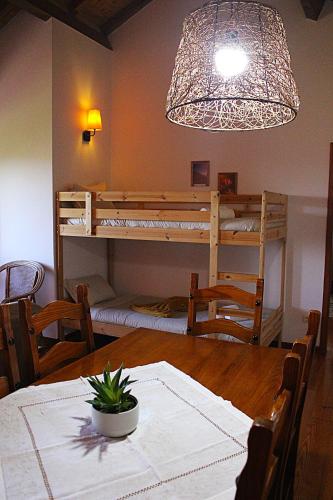 a dining room with a table and a bunk bed at Casa da Comareira in Góis