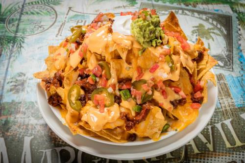 a plate of nachos with salsa and gu peppers at Margaritaville Hollywood Beach Resort in Hollywood