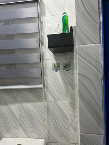 a bathroom with a shower with a glass wall at RYN Apartment Ayobo-Ishefun, Lagos Flat1 in Itele