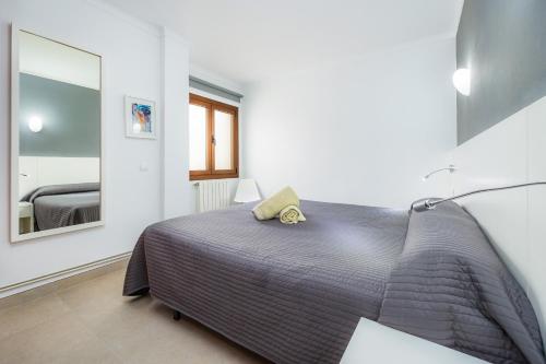 a bedroom with a bed and a mirror at Cala Figuera Apartment 3b in Cala Figuera