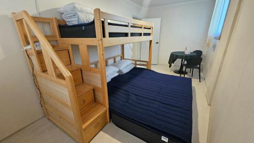 a bedroom with a bunk bed with a ladder at Air Jinju in Jinju