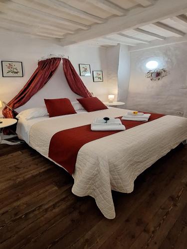 a large bedroom with a large bed with red pillows at Antiche Mura in Arezzo