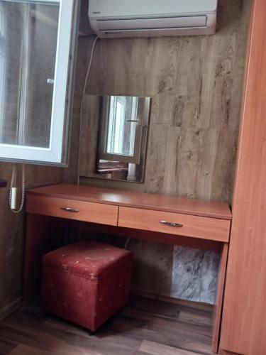 a dressing table with a mirror and a red stool at Hostel Center Plovdiv in Plovdiv