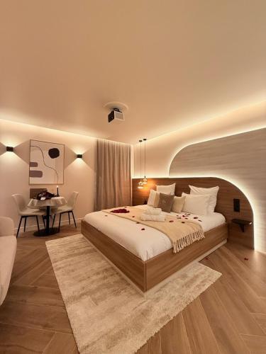 a bedroom with a large bed and a desk at Maison Nina, Suite d’exception in LʼÎle-Saint-Denis