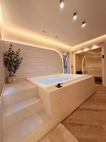 a jacuzzi tub in a room with stairs at Maison Nina, Suite d’exception in LʼÎle-Saint-Denis