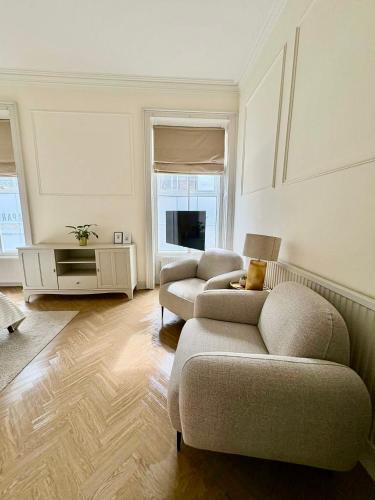 a living room with two couches and a tv at 'Blair' in ApartNest Auchterarder in Auchterarder