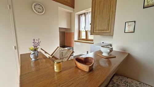 a kitchen with a wooden counter top in a room at Le clédier de cherveix in Solignac