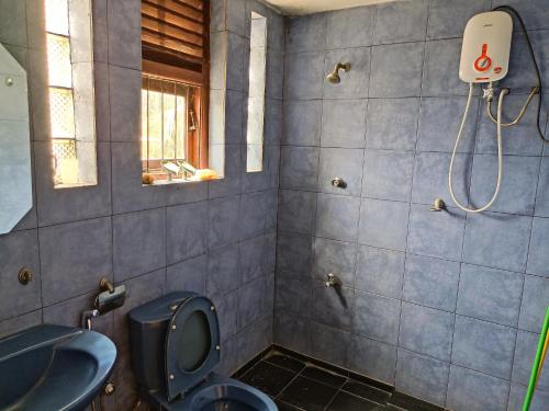 a bathroom with a toilet and a sink at LP Residence in Pannipitiya