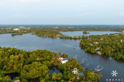 an aerial view of a river with trees at Zostel Kochi, Kumbalangi in Cochin