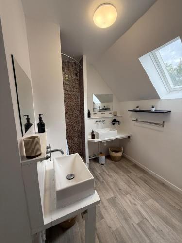 a white bathroom with two sinks and a window at Casa Limon, Charm & Serenity in Cesson-Sévigné