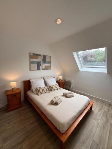 a bedroom with a bed with two towels on it at Casa Limon, Charm & Serenity in Cesson-Sévigné