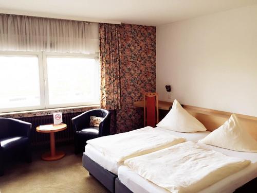 En eller flere senge i et værelse på Hotel Imperial