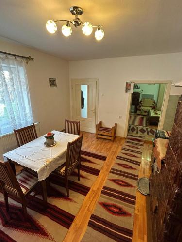 a dining room with a table and chairs in a room at Krausz Chocolate Guesthouse in Sîntimbru