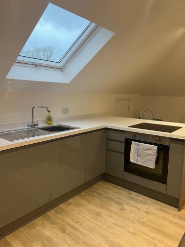 a kitchen with a sink and a window at Penthouse new 2 bed 2 apartment in Basingstoke