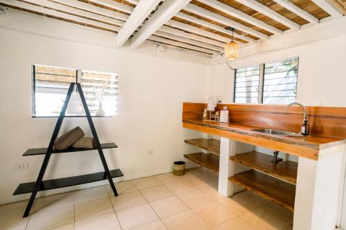 a kitchen with a sink and a wooden counter at Alaya Panglao in Panglao Island