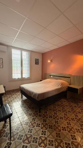a bedroom with a large bed in a room at Hotel restaurant LAISSAC SPEISER in Olargues