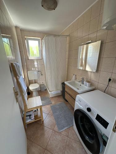 a washing machine in a bathroom with a sink at Panorama in Drvenik Veli