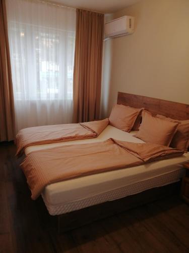 a large bed in a room with a window at Апартамент Light blue in Troyan