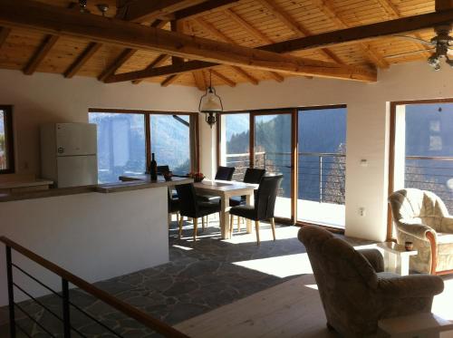 a kitchen and dining room with a table and chairs at Sabri's Penthouse in Ogled