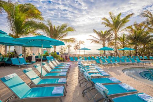 a group of chairs and umbrellas next to a pool at Margaritaville Hollywood Beach Resort in Hollywood