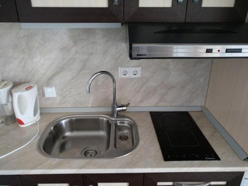 a kitchen counter with a sink and a microwave at Oasis Resort&Spa Lozenets Studio 12 in Lozenets