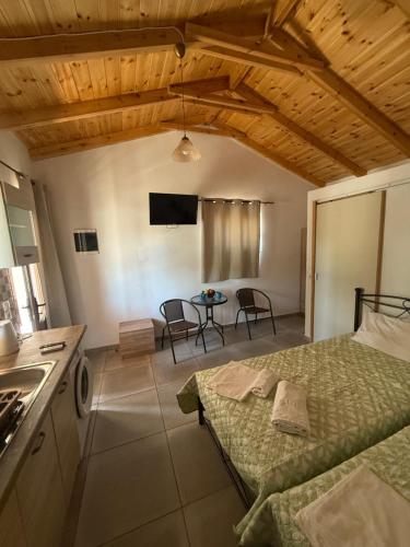 a room with a bed and a kitchen with a table at Kamares Bay Escape in Gythio