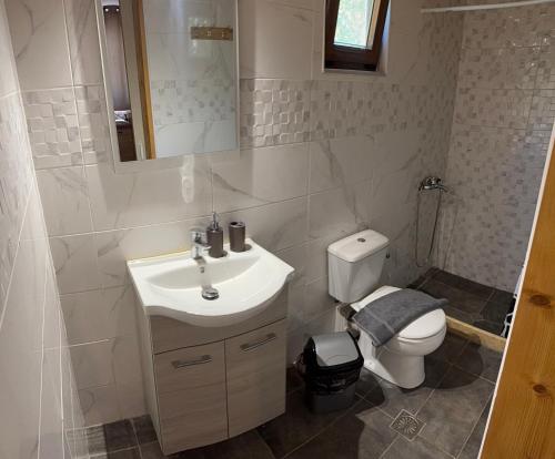 a bathroom with a sink and a toilet at Kamares Bay Escape in Gythio