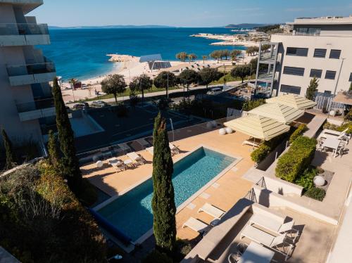 an aerial view of a resort with a swimming pool and the ocean at Eol Apartments Split Žnjan Beach in Split