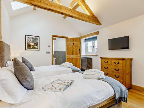 a bedroom with two beds and a tv on the wall at 2 Bed in Taunton oc-80694 in North Curry