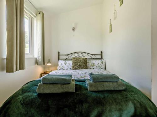 a bedroom with a large bed with pillows on it at 1 Bed in Llangammarch Wells oc-bn020 in Garth