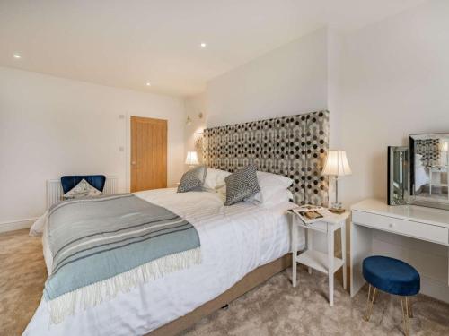 a bedroom with a large bed and a desk at 3 Bed in Poulton-le-fylde oc-83787 in Hambleton