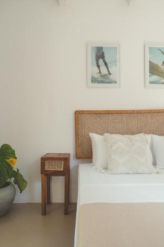 a bedroom with a bed and a side table at Casa Mariposa in Ahangama