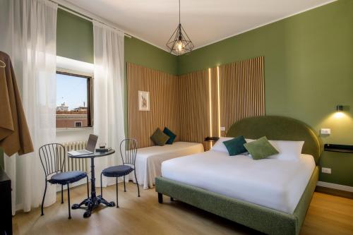 a bedroom with two beds and a table with a laptop at Al centro di Roma in Rome
